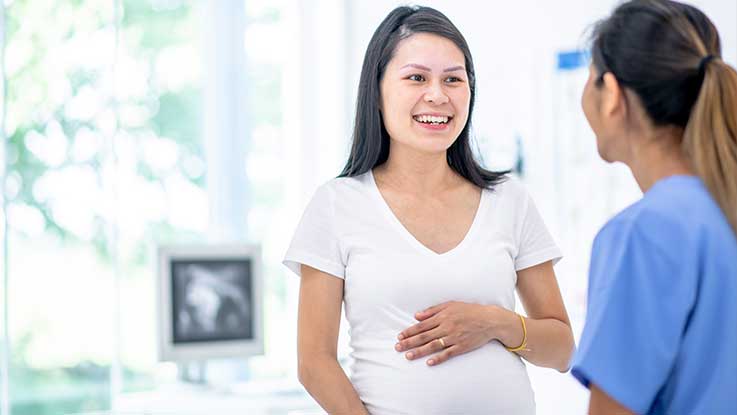 A doctor discussing a birth plan with a pregnant patient.