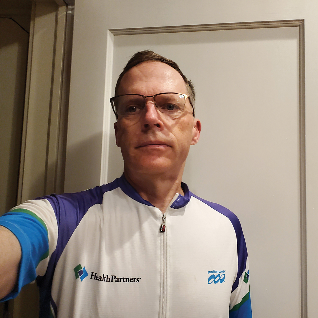 Evan Page takes a selfie in a biking jersey.