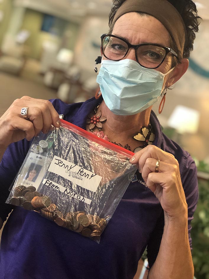 Jenny holds up a Ziploc bag with pennies inside, given to her by a young patient.