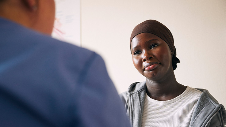 A young woman looking kindly at her therapist.