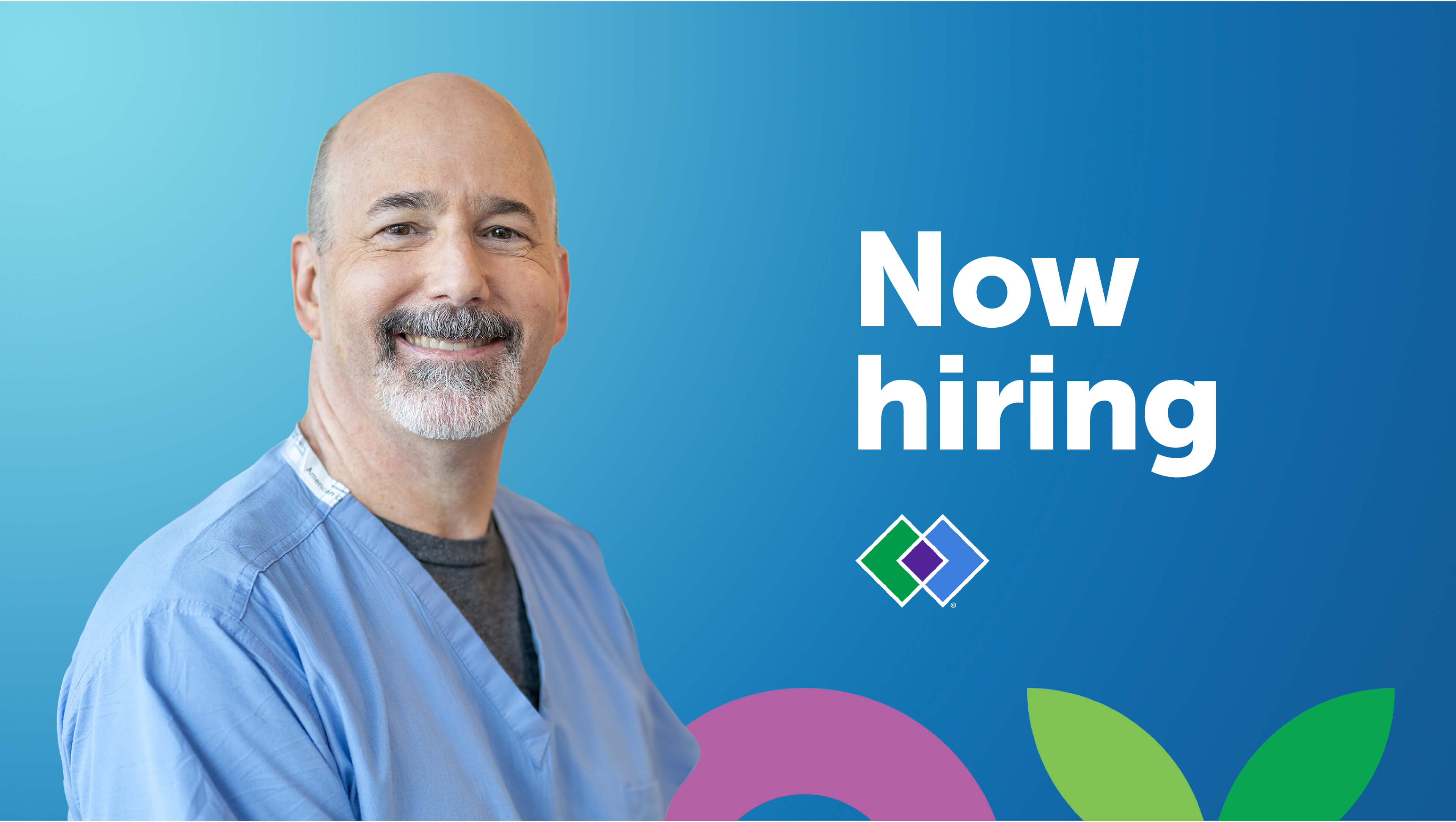 A doctor who works at HealthPartners smiles in front of a background that says “Now hiring.”