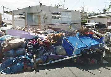 Various supplies and belongings are strewn about on a San Juan street.