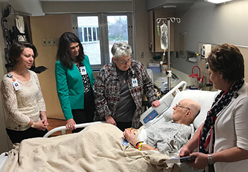 the Lee and Penny Anderson HeroCare team visits with World War II Veteran