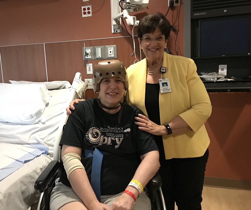 Regions Hospital Experience Ambassador Jackie Edwards, right, visits with Sarah Stanley in recovery.