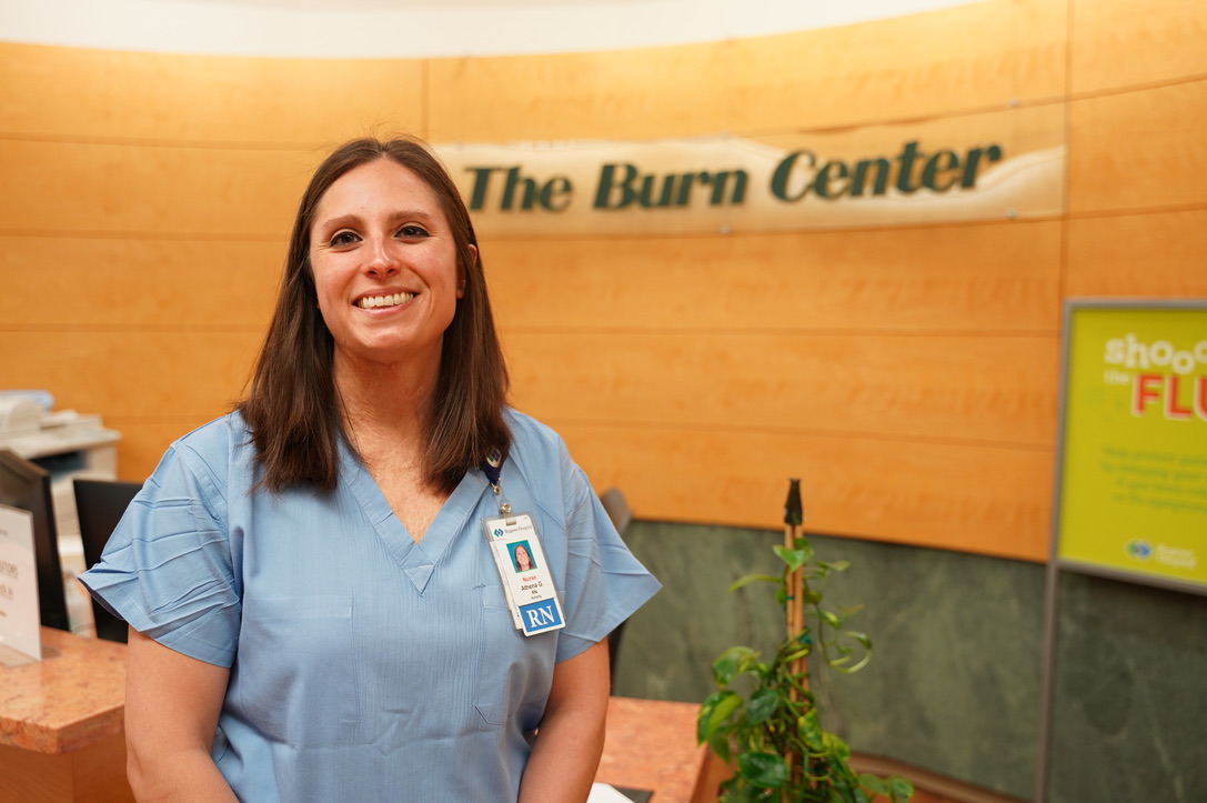 image: Athena standing in front of The Burn Center sign